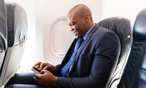 man on plane with mobile device, Xerox, Connect Key, Oregon Office Solutions, Oregon, Newport, Bend, Salem, Xerox, HP, MFP, Printer, Copier